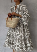 Vestido midi estampado con escote en V y manga tres cuartos
